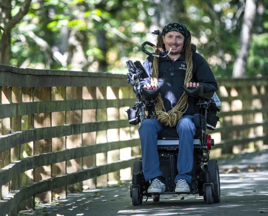 Image shows man on a motorised wheelchair